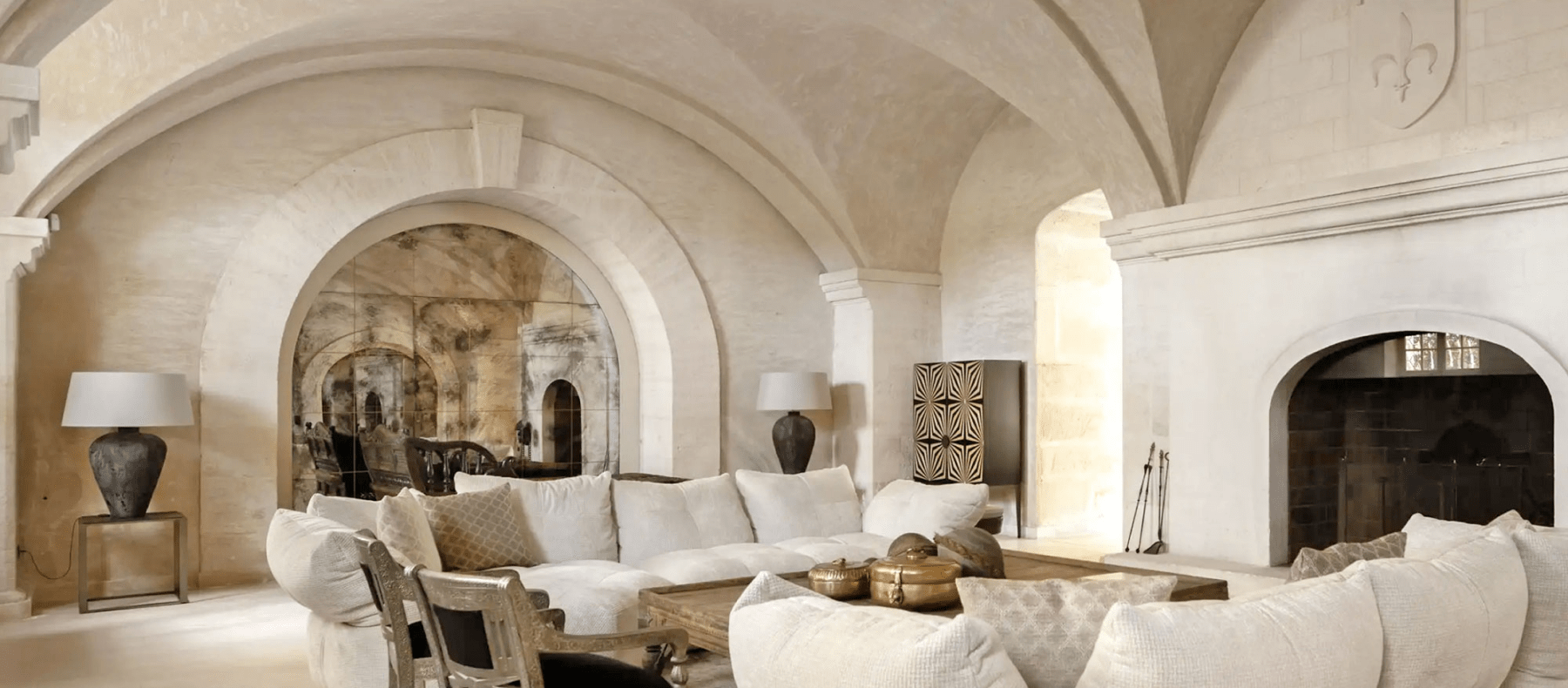 Comfy living area with cream sofa and marble walls